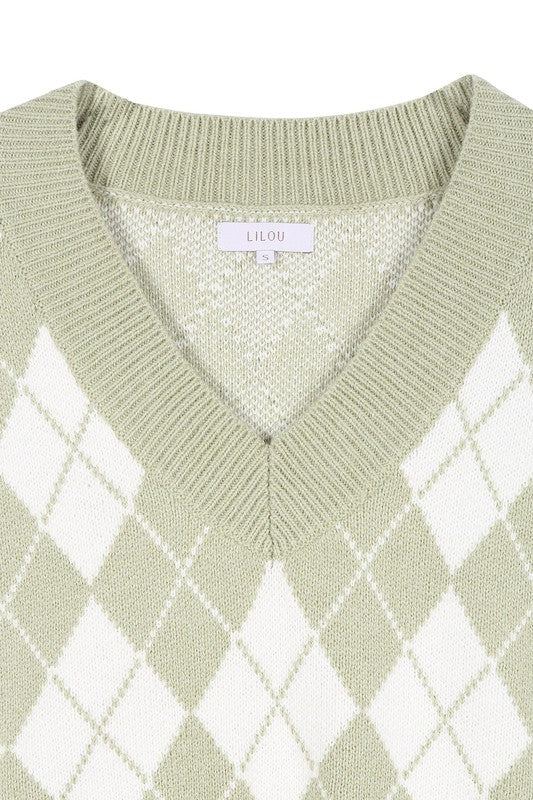 A person wearing a knitted argyle sweater vest in light green over a white shirt stands against a neutral background.