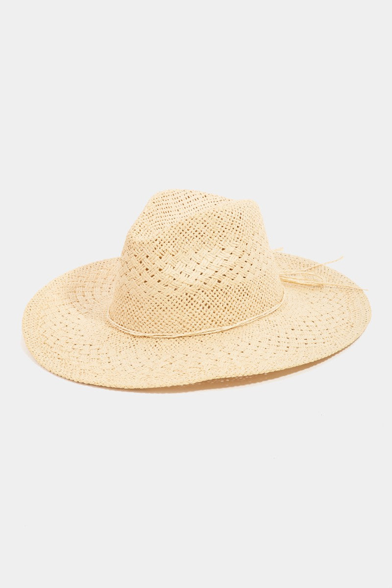 The Fame Straw Braided Sun Hat, with its wide brim and textured purple design, provides outstanding sun protection, making it an ideal summer accessory against a plain white background.