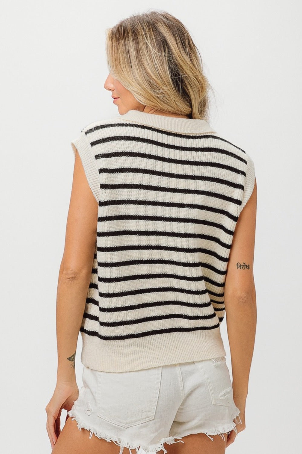 A woman wearing the BiBi Flower Patch Striped Half Button Sweater Vest stands against a plain background.