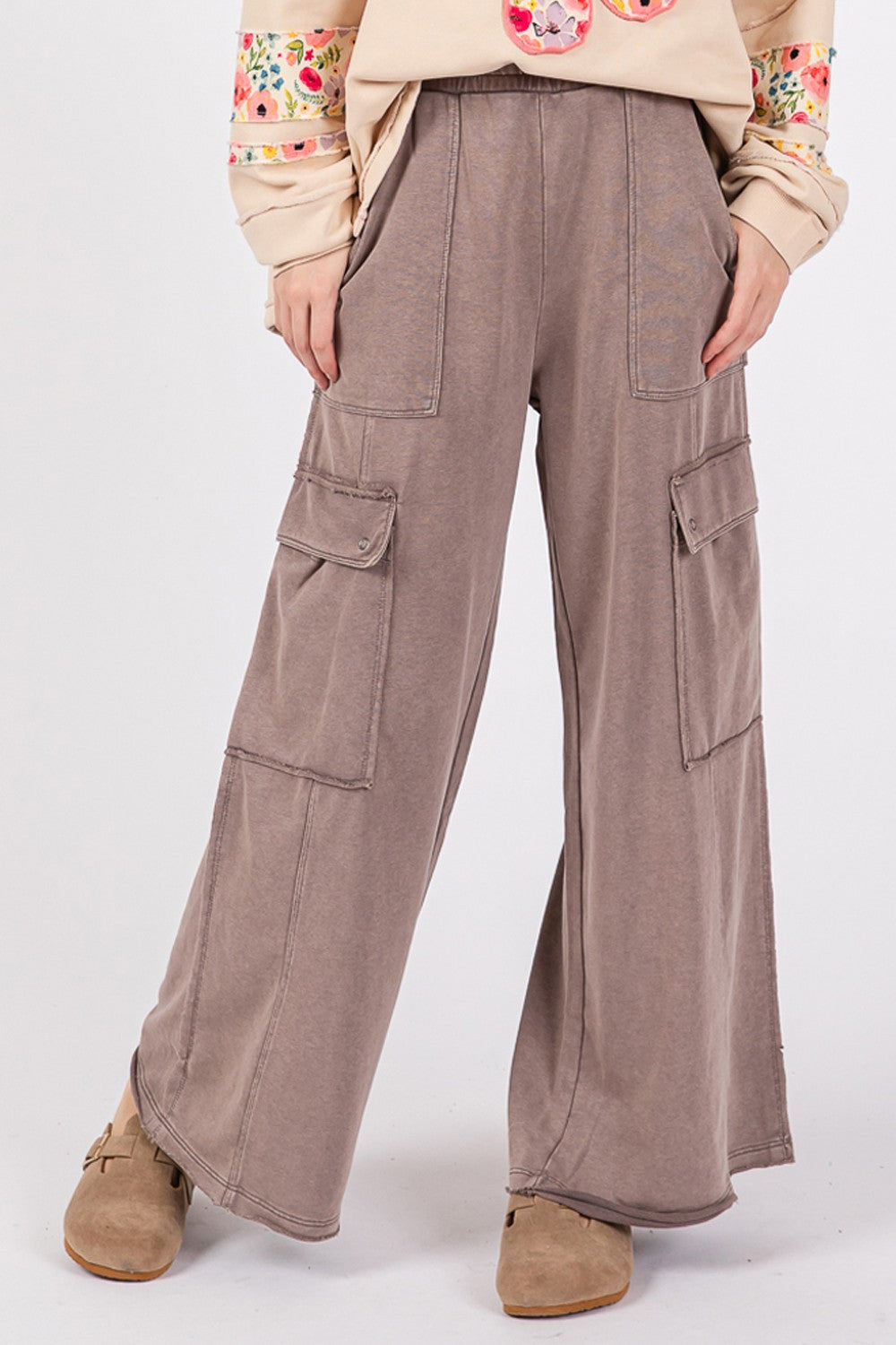 A person wearing SAGE + FIG Knit Terry Mineral Wash Wide Leg Pants in brown and beige shoes stands against a plain background.