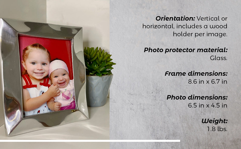 The Stylish Picture Frame is a minimalist design crafted from recycled aluminum, showcasing a silver finish with a plain brown backing and supported by a wooden stand at the back.