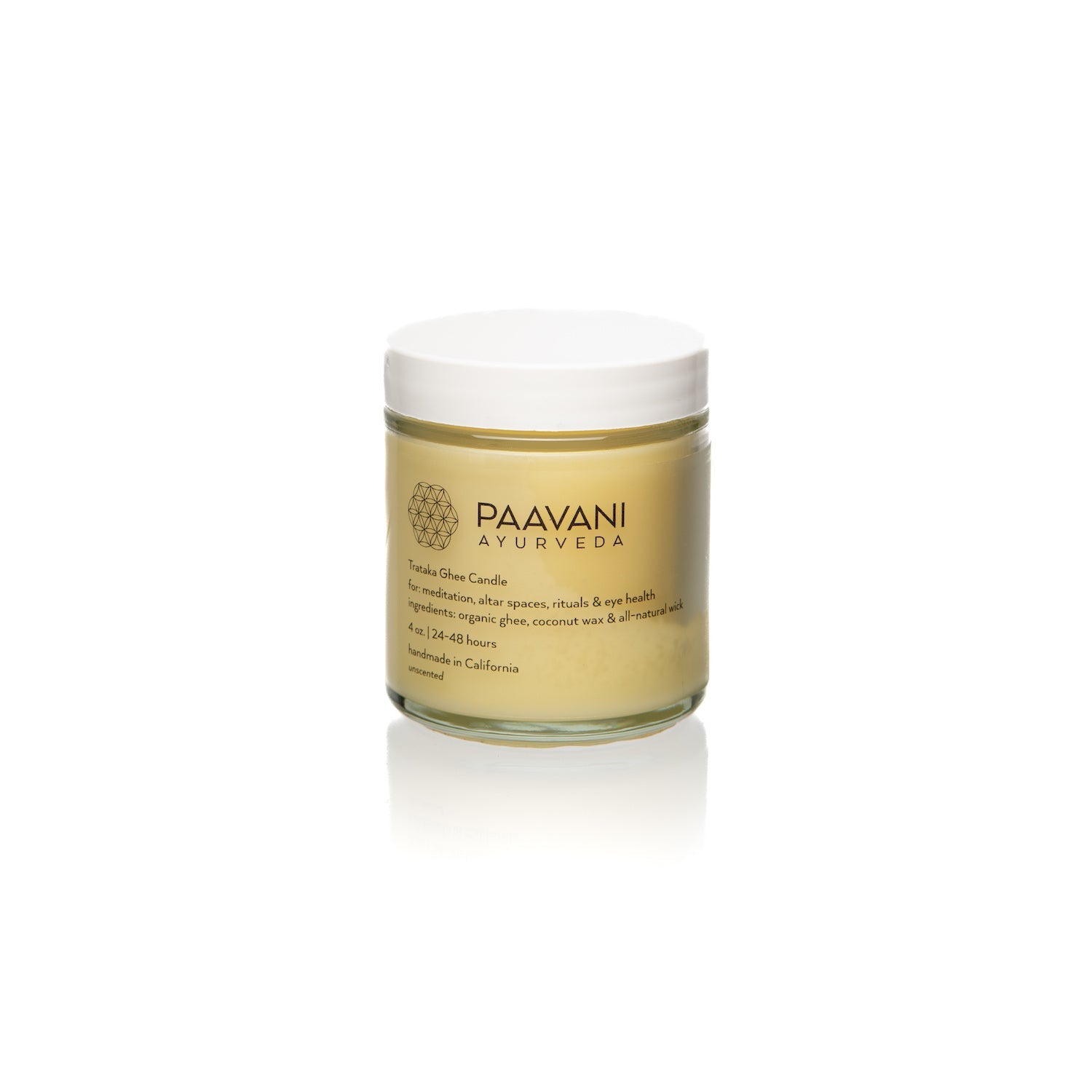 The Trataka Ghee Candle, encased in a glass jar labeled "PAAVANI," features a yellow balm crafted with turmeric, coconut wax, and essential oils. Inspired by Trataka practices, its soothing ingredients are designed to potentially enhance eye health.