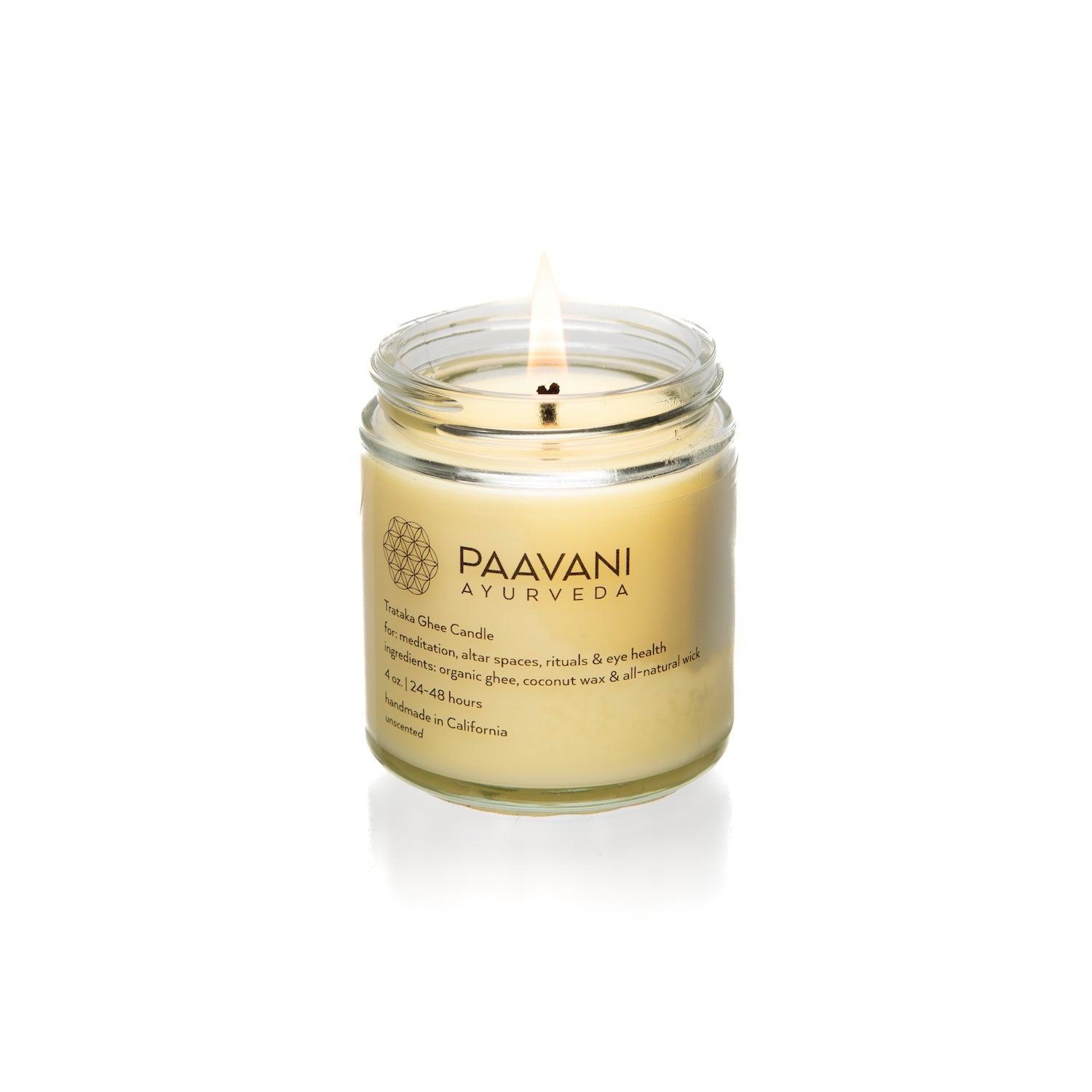 The Trataka Ghee Candle, encased in a glass jar labeled "PAAVANI," features a yellow balm crafted with turmeric, coconut wax, and essential oils. Inspired by Trataka practices, its soothing ingredients are designed to potentially enhance eye health.