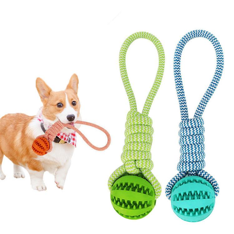 A durable rubber ball chew toy with cotton rope for dogs.