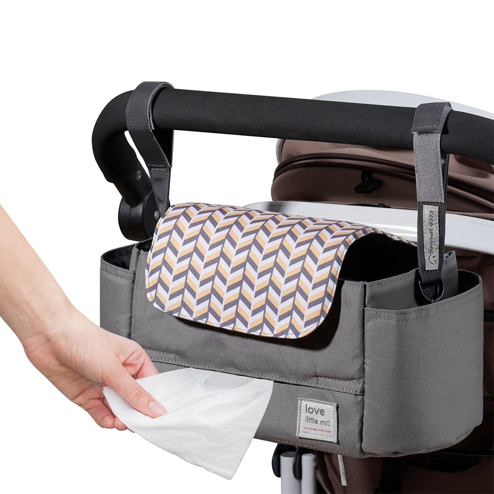 A man and woman with a baby in a High Capacity Stroller Organizer.