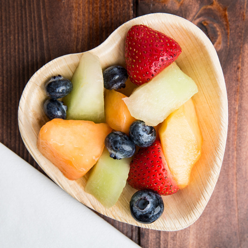 The Heart Palm Leaf Plates are eco-friendly, crafted with a smooth, light brown surface and visible grain patterns, available in sets of 50, 100, or 200.