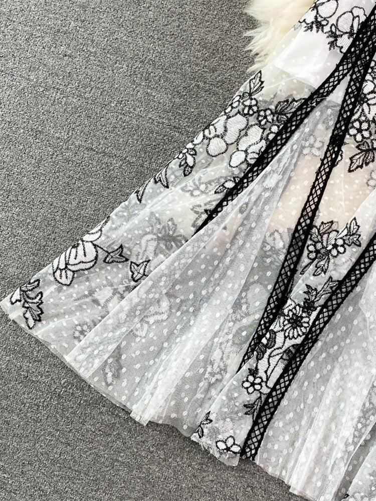 An High Quality Embroidery Mesh Long Dress For Women Vintage Lace Hollow with floral patterns, black trim, and a waist ribbon displayed on a mannequin against a vintage lace background.