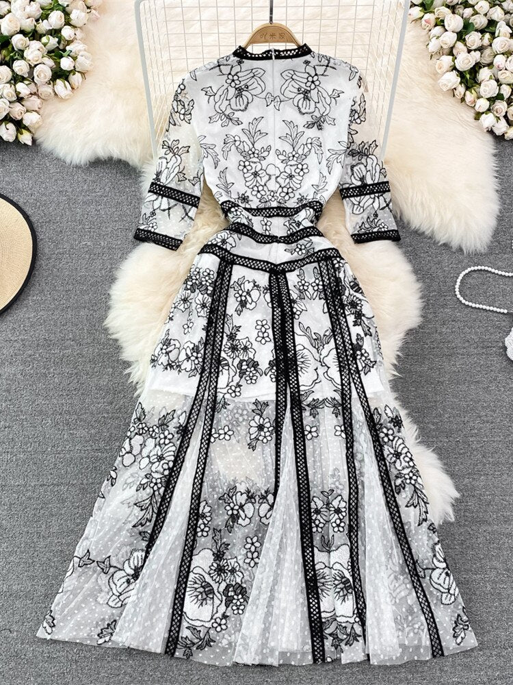 An High Quality Embroidery Mesh Long Dress For Women Vintage Lace Hollow with floral patterns, black trim, and a waist ribbon displayed on a mannequin against a vintage lace background.