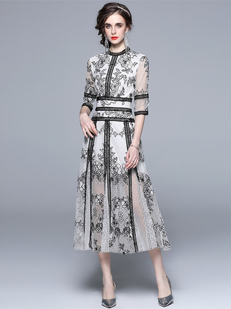 An High Quality Embroidery Mesh Long Dress For Women Vintage Lace Hollow with floral patterns, black trim, and a waist ribbon displayed on a mannequin against a vintage lace background.