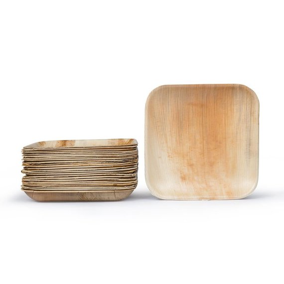 A collection of Palm Leaf Square Plates 9" Inch (Set of 100/50/25), resembling eco-dinnerware, is displayed alongside a solitary plate against a simple background.