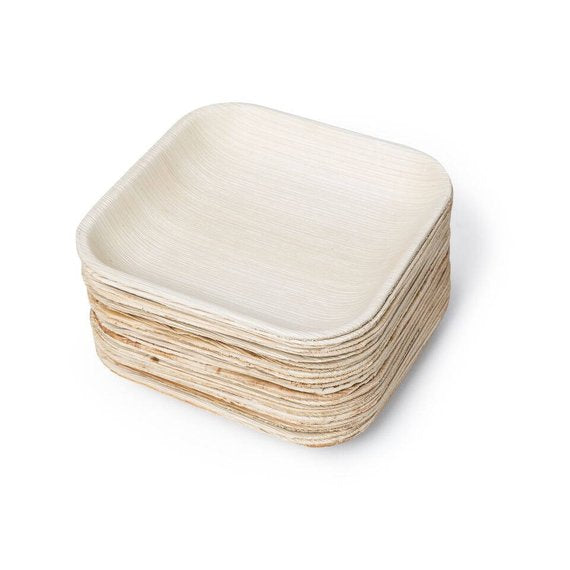 A collection of Palm Leaf Square Plates 7" Inch, featuring a textured natural finish, resting against each other on a white background. These 100% compostable gems offer an elegant and sustainable reimagining of eco-dinnerware.