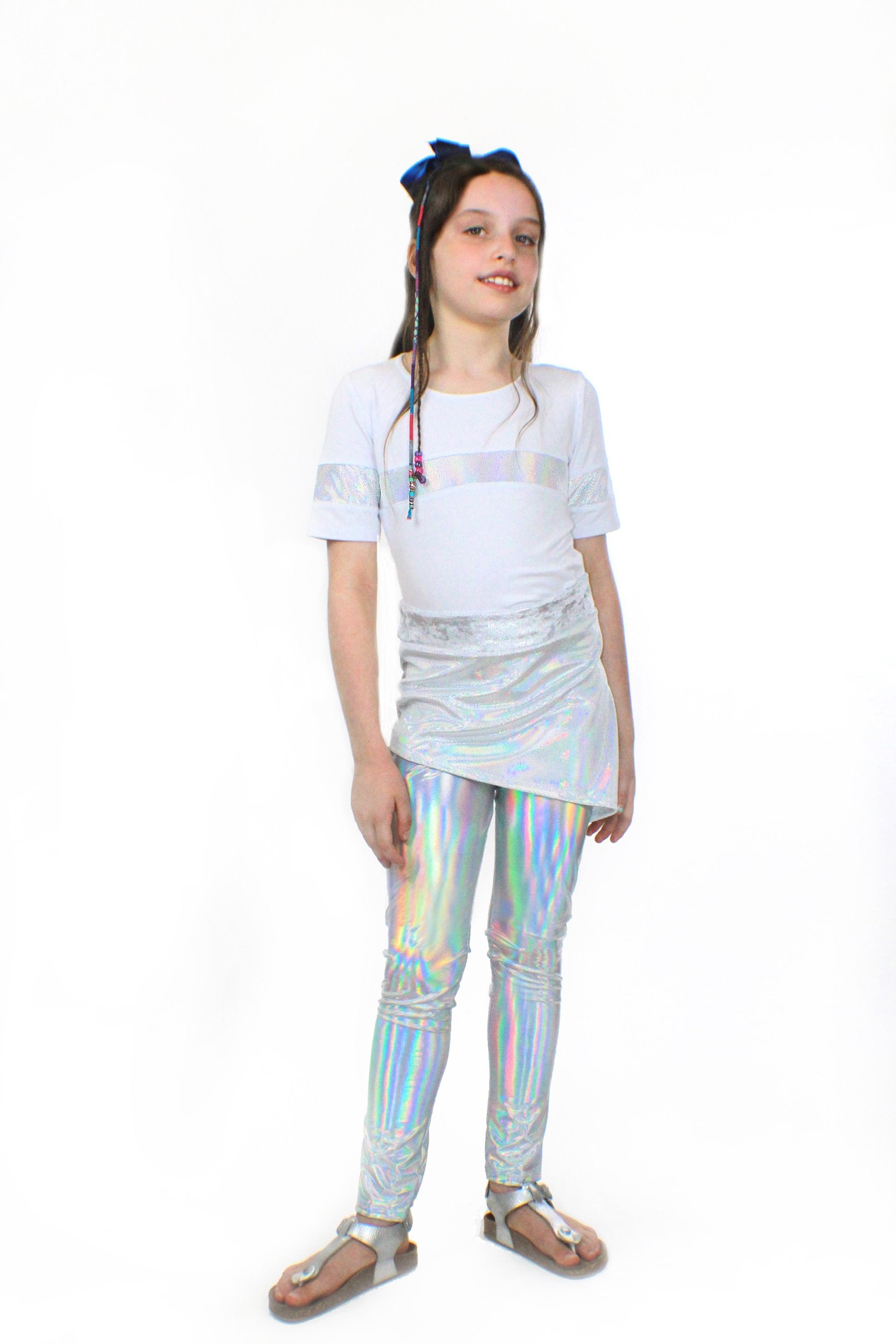 A girl wearing Mia, dizzy unicorn stretch Pants by Sky Blue Beech and a white t - shirt.