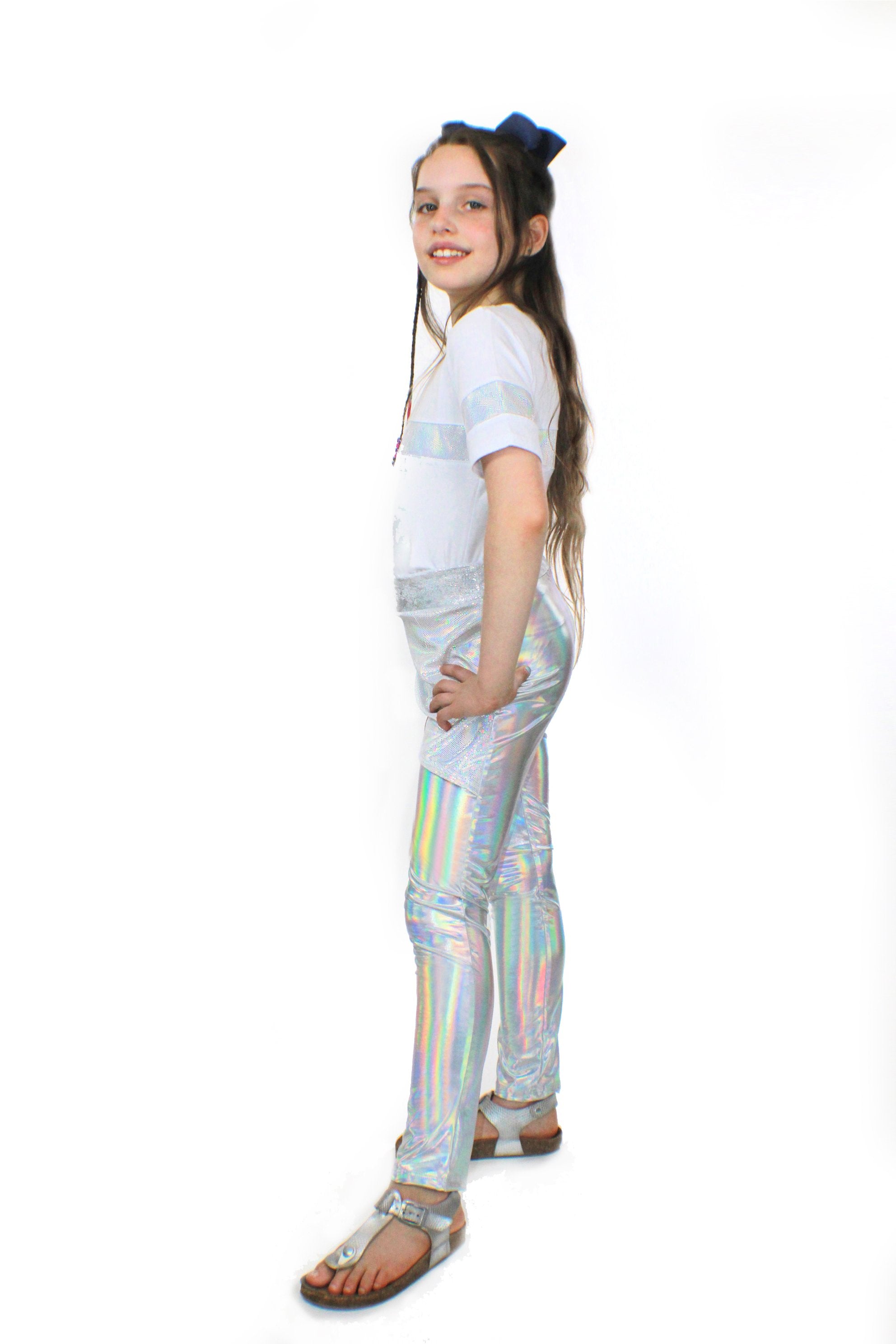 A girl wearing Mia, dizzy unicorn stretch Pants by Sky Blue Beech and a white t - shirt.