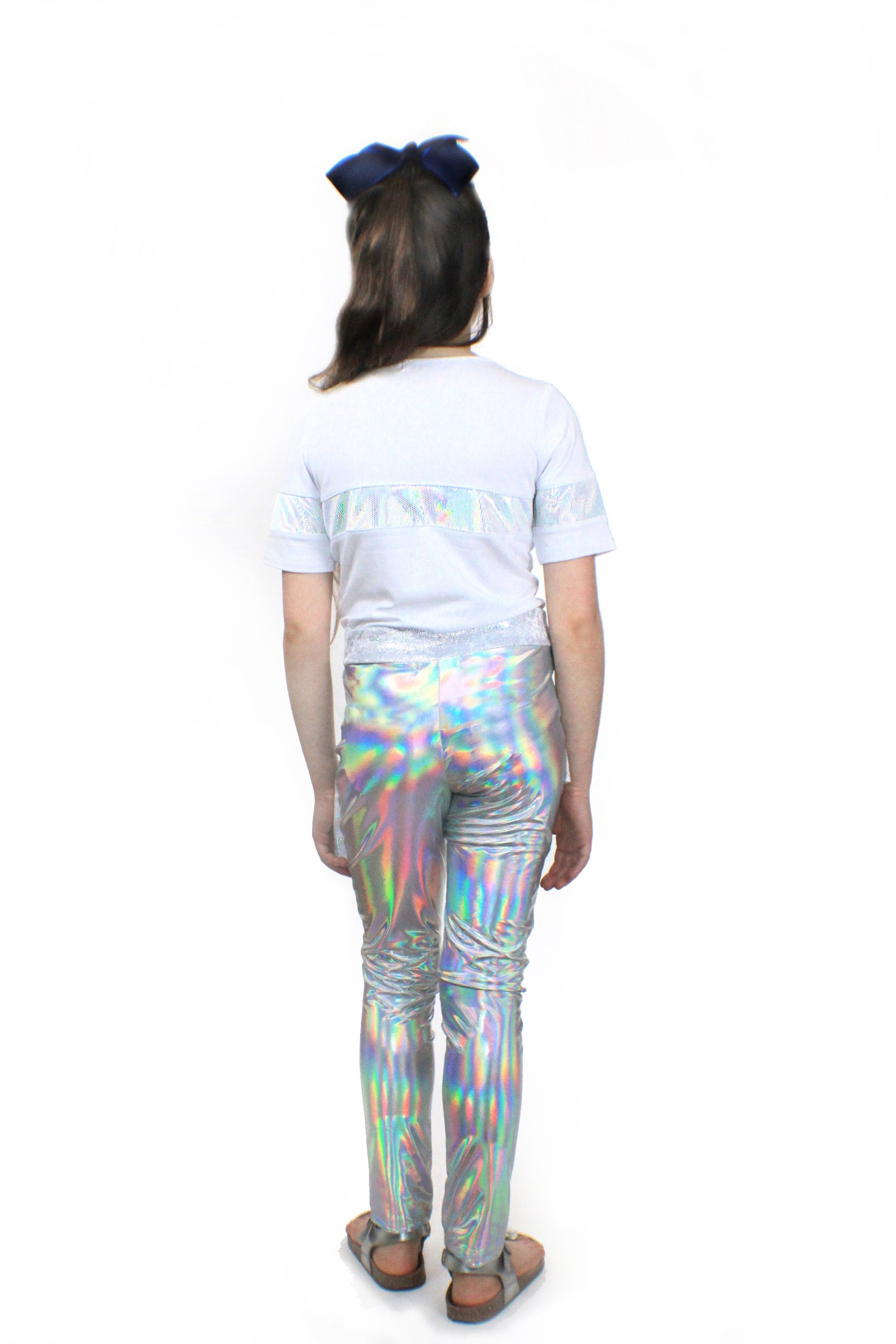 A girl wearing Mia, dizzy unicorn stretch Pants by Sky Blue Beech and a white t - shirt.