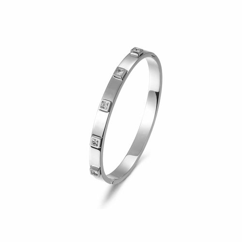 The Metal Stone Hinged Bangle is a sleek 14K gold PVD plated stainless steel bracelet, featuring square diamond accents evenly spaced along its hypoallergenic band.