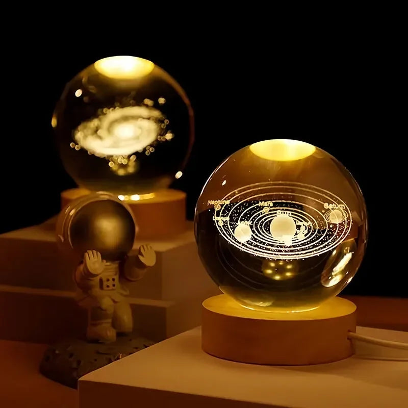 The 60cm 3D Crystal Ball Glass Ball Warm Night Light sits elegantly on a wooden base, showcasing a stunning solar system galaxy model. Nearby, an astronaut figurine adds to the scene's charm in a softly lit room. Experience quick delivery and safe transactions for this extraordinary astronomy-inspired home decoration.