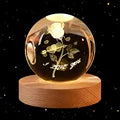 Displaying a brand new solar system design, two 60cm 3D Crystal Ball Glass Balls with warm night lights sit atop wooden bases, accompanied by a small astronaut figure.