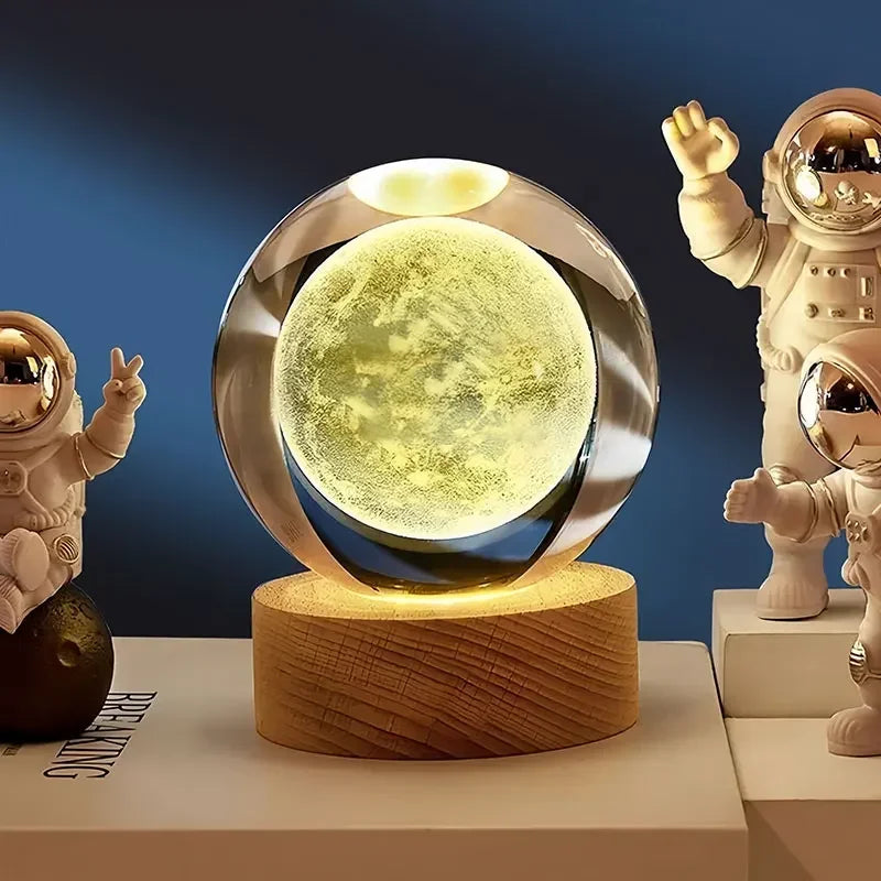 Displaying a brand new solar system design, two 60cm 3D Crystal Ball Glass Balls with warm night lights sit atop wooden bases, accompanied by a small astronaut figure.