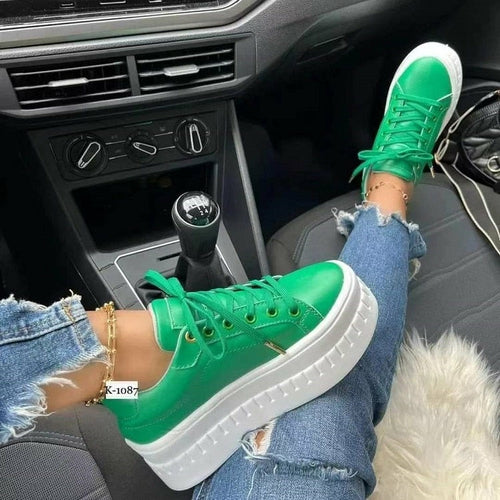 A woman sitting in a car wearing Casual Platform Women's Shoes Flat Womens Sneakers while referencing a shoes size chart.