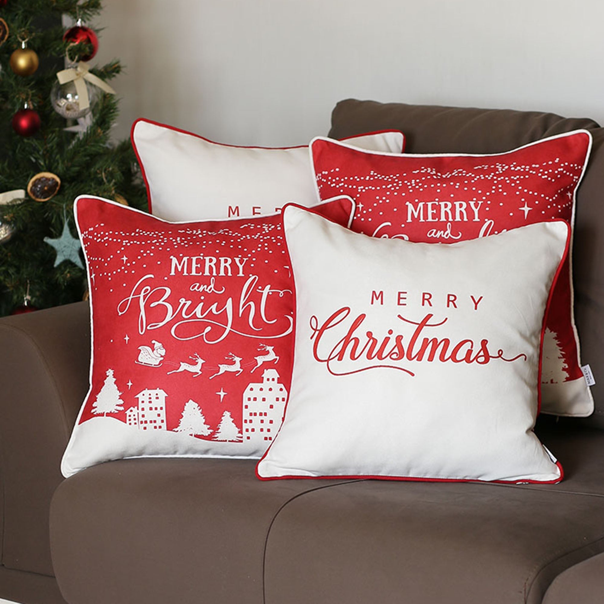 Arranged on a brown sofa near a Christmas tree are four Decorative Merry Christmas Throw Pillow Covers, each measuring 18" x 18", in white and red. These pillow covers boast luxurious brushed fabric with "Merry Christmas" and "Merry and Bright" text, featuring OEKO-TEX Standard 100 certified materials.