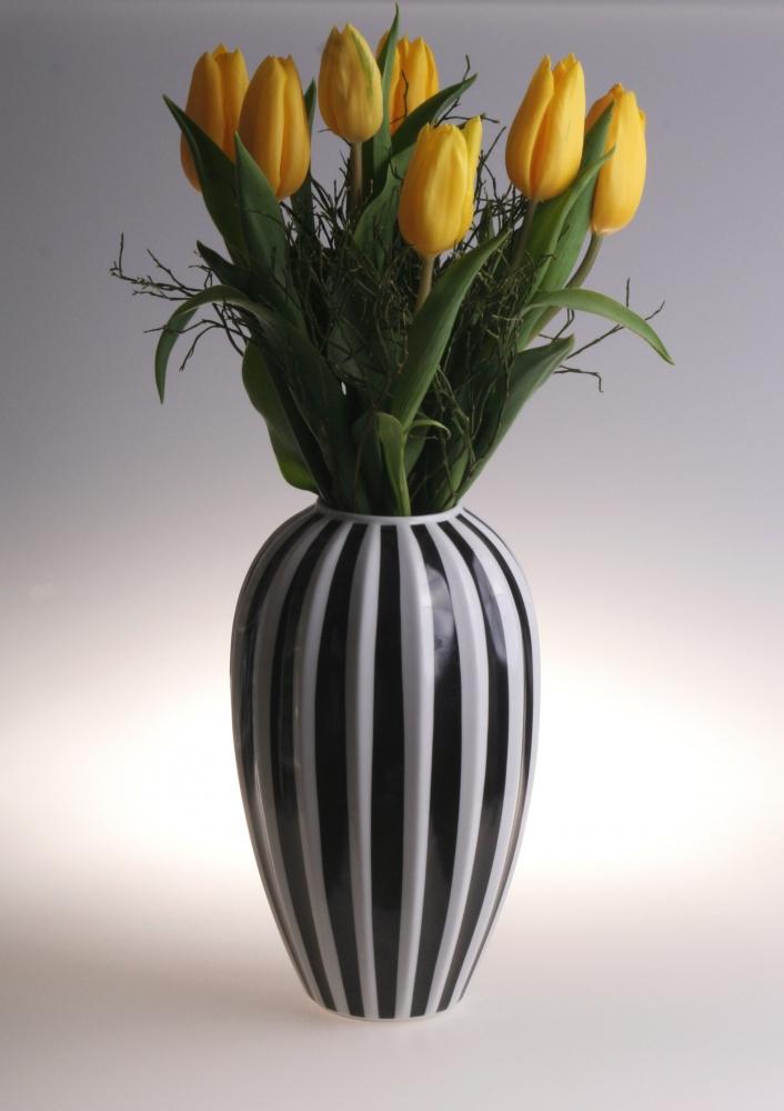 A Retro Style Porcelain Flower Vase by Pink Aether, filled with yellow tulips.