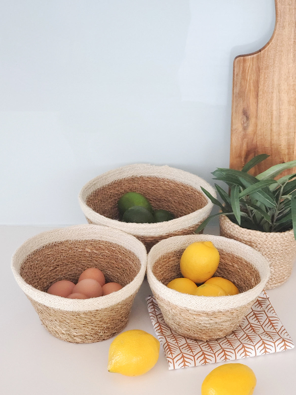 The Savar Plant Bowl Set, featuring three woven bowls of different sizes crafted by Fair Trade artisans, is arranged against a plain background.