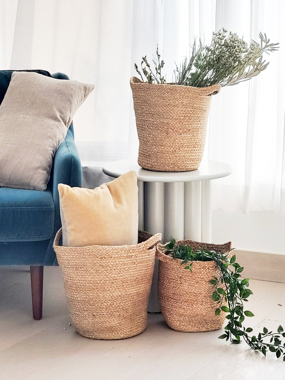 The Kata Basket with Slit Handle, crafted by Fair Trade artisans, is a set of three handwoven pieces that feature varying sizes and are elegantly displayed against a white background.