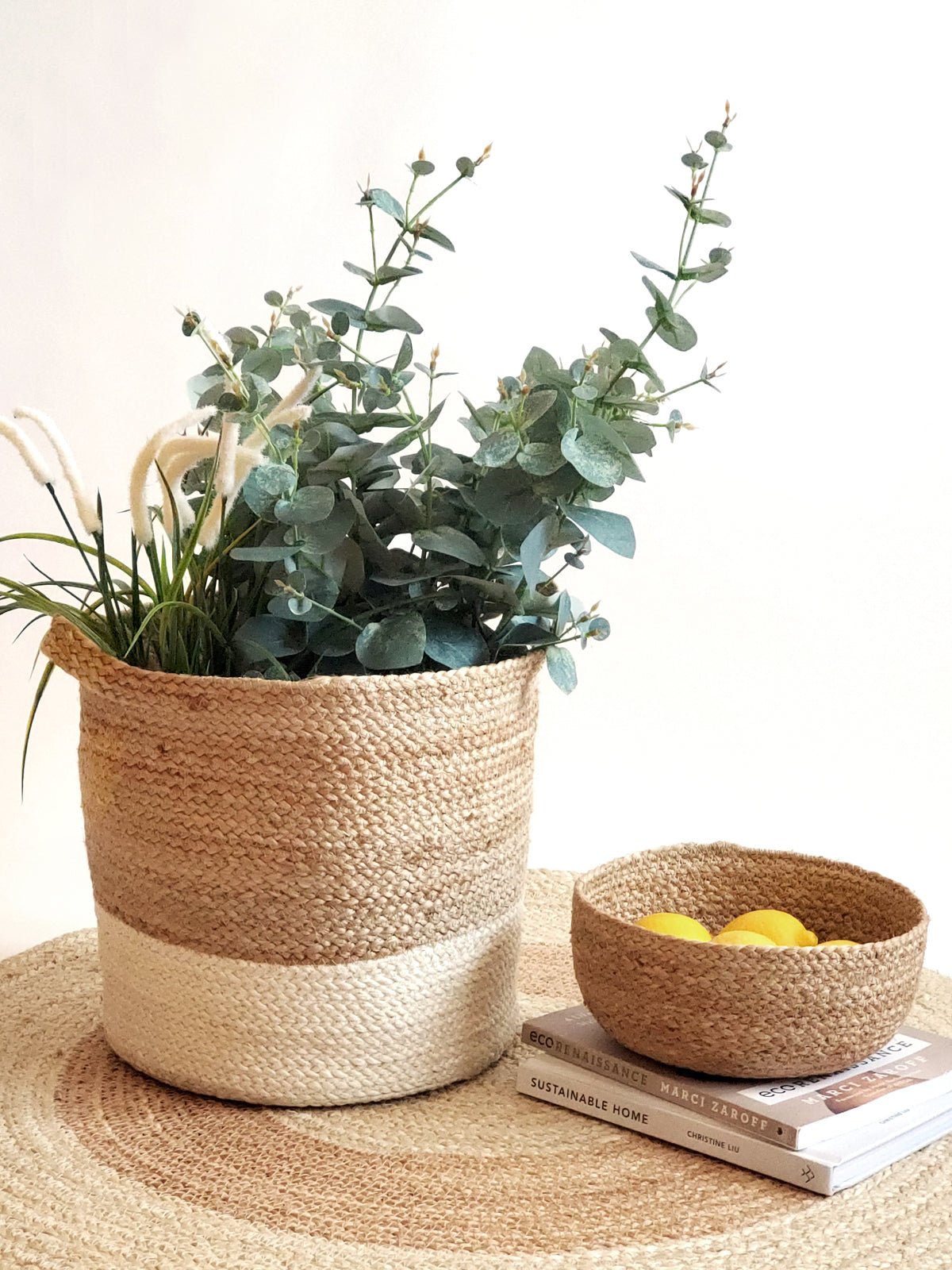 Two Kata Colorblock baskets with handles, featuring a two-tone design in natural and white fibers, crafted by Fair Trade artisans.