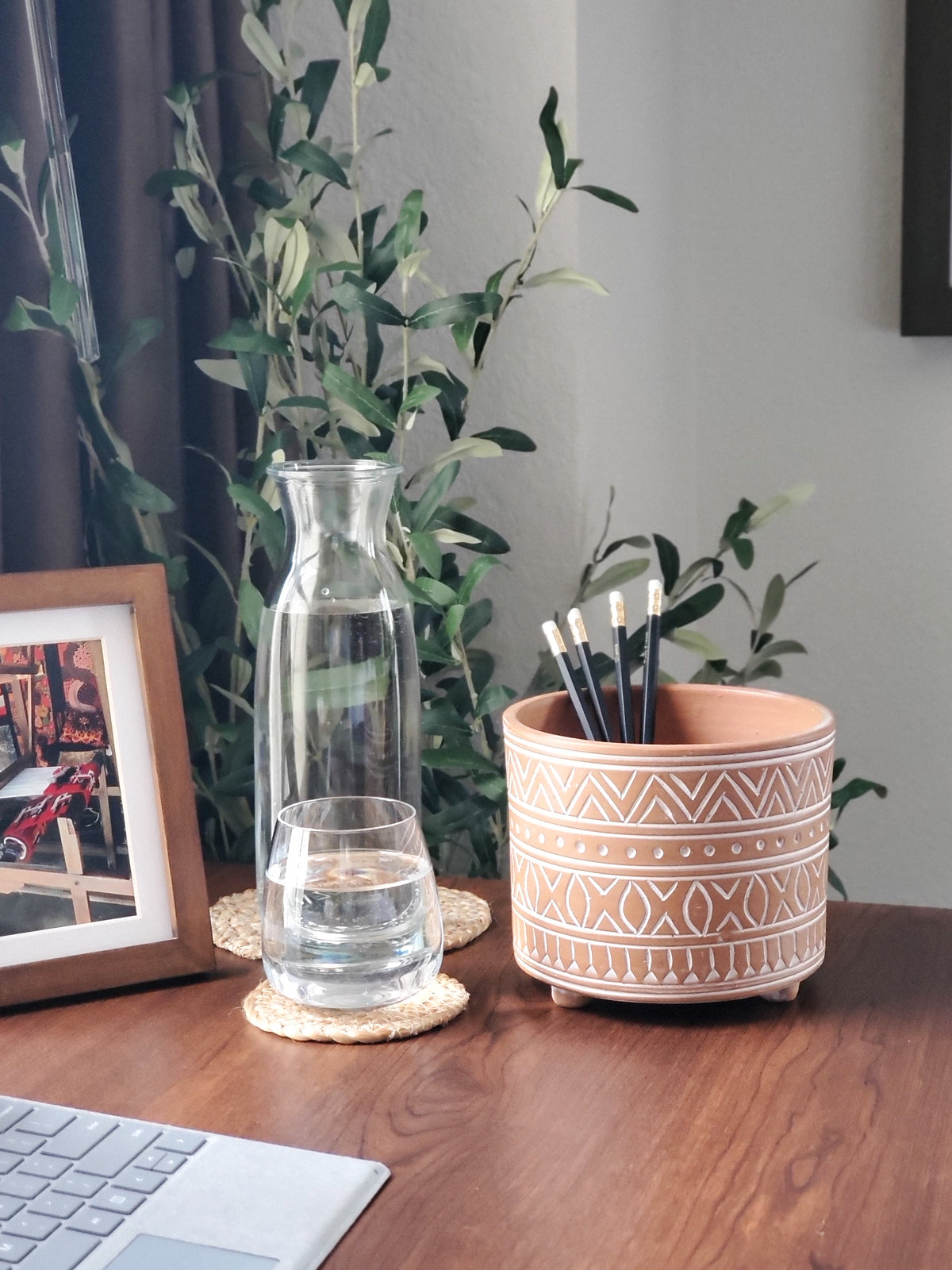 The Hand Etched Terracotta Pot - Small, featuring intricate artisan-inspired white patterns, stands elegantly against a plain background.