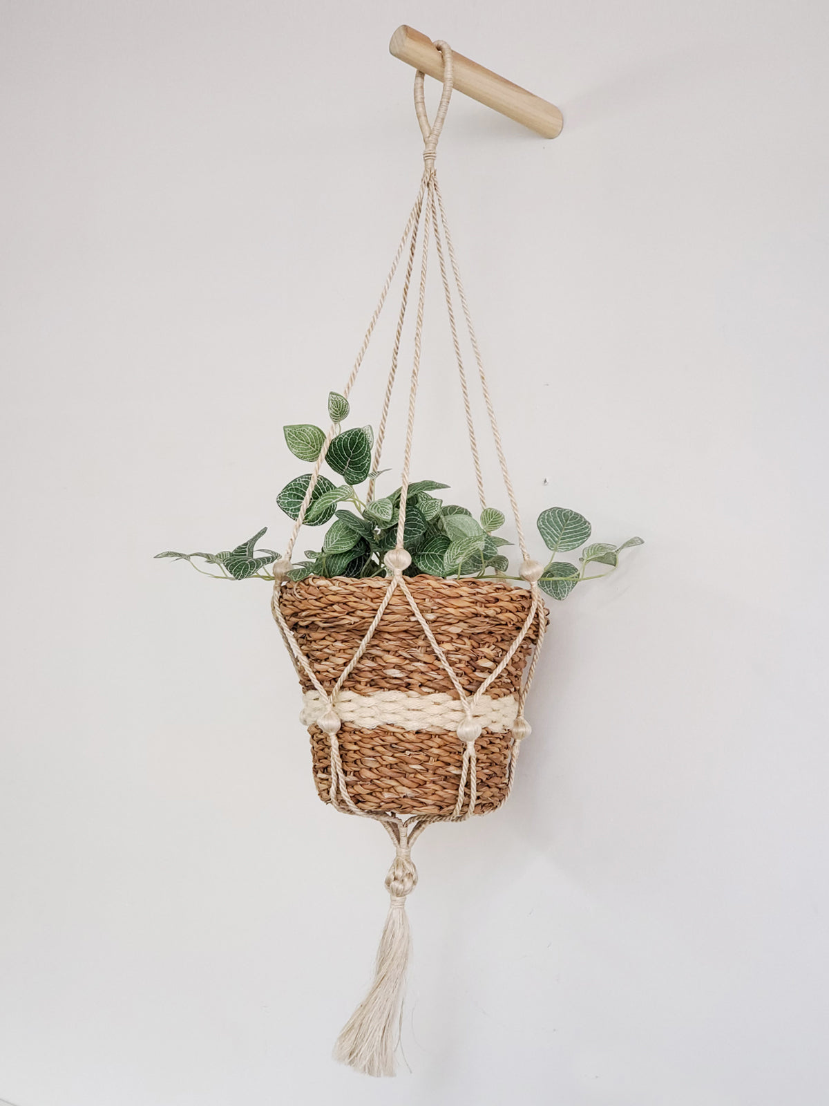 Three Savar Nesting Plant Baskets, crafted by Fair Trade artisans, feature white stripe accents. Two are stacked upright while one lies sideways on a plain background, showcasing their sustainable beauty.