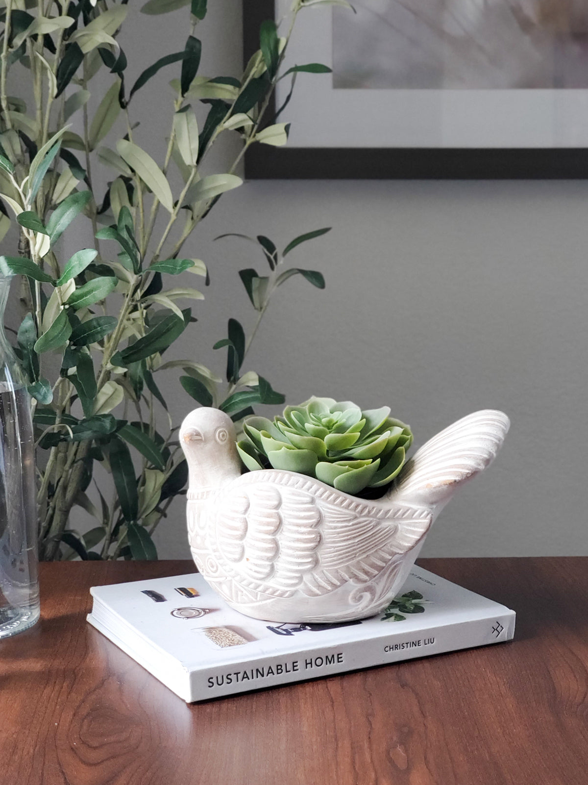 The Turtle Dove Terracotta Pot, intricately patterned and shaped like a graceful bird with a detailed tail, crafted meticulously by fair trade artisans, rests on a plain background.