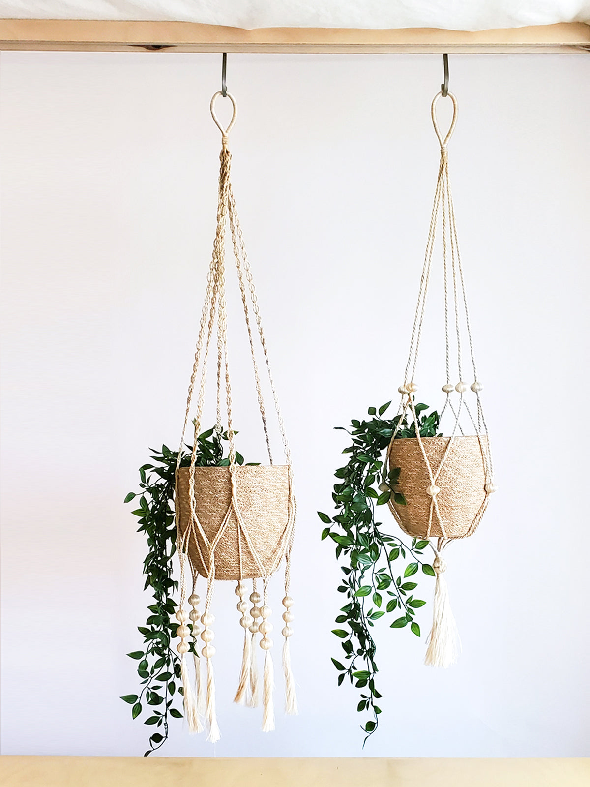 Two Agora Bins, handcrafted woven baskets of varying sizes, made with Fair Trade Jute Yarn, are placed side by side against a plain background.