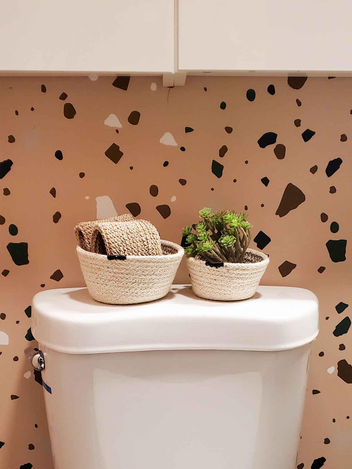 A set of three Amari Bowls in black, handmade beige woven jute baskets of varying sizes by Fair Trade artisans, arranged on a plain background.