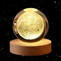 Displaying a brand new solar system design, two 60cm 3D Crystal Ball Glass Balls with warm night lights sit atop wooden bases, accompanied by a small astronaut figure.