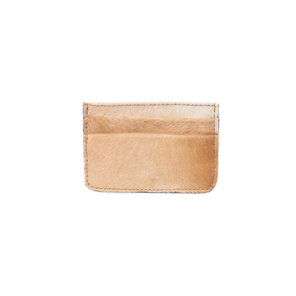 The Coco Card Holder is a minimalist tan and cream cowhide leather accessory, complete with stitched edges and practical card slots.