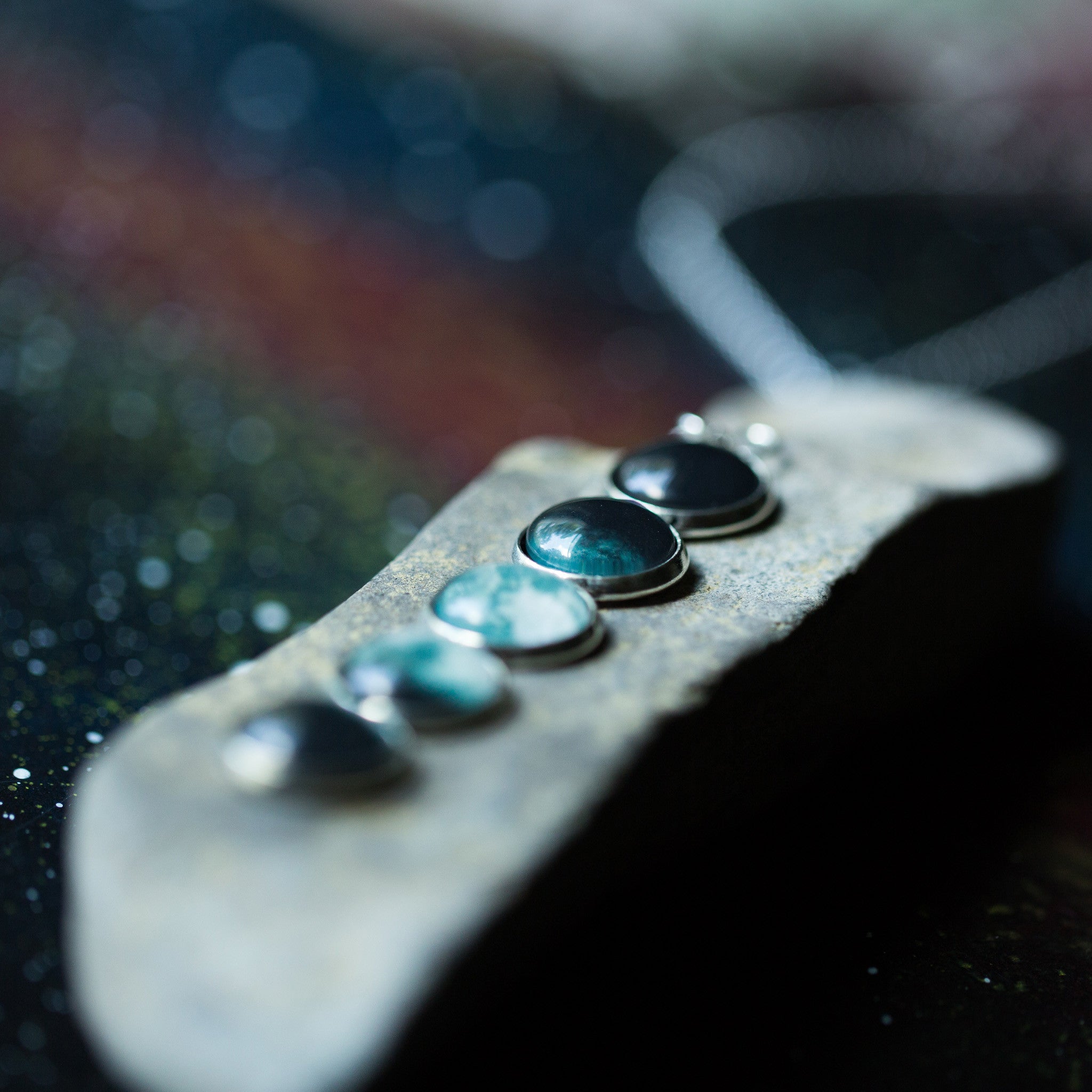 Introducing the Moon Phase Pendant Necklace: a breathtaking piece adorned with five round pendants, each beautifully depicting the phases of the moon against a starry background, capturing the splendor of the lunar cycle.