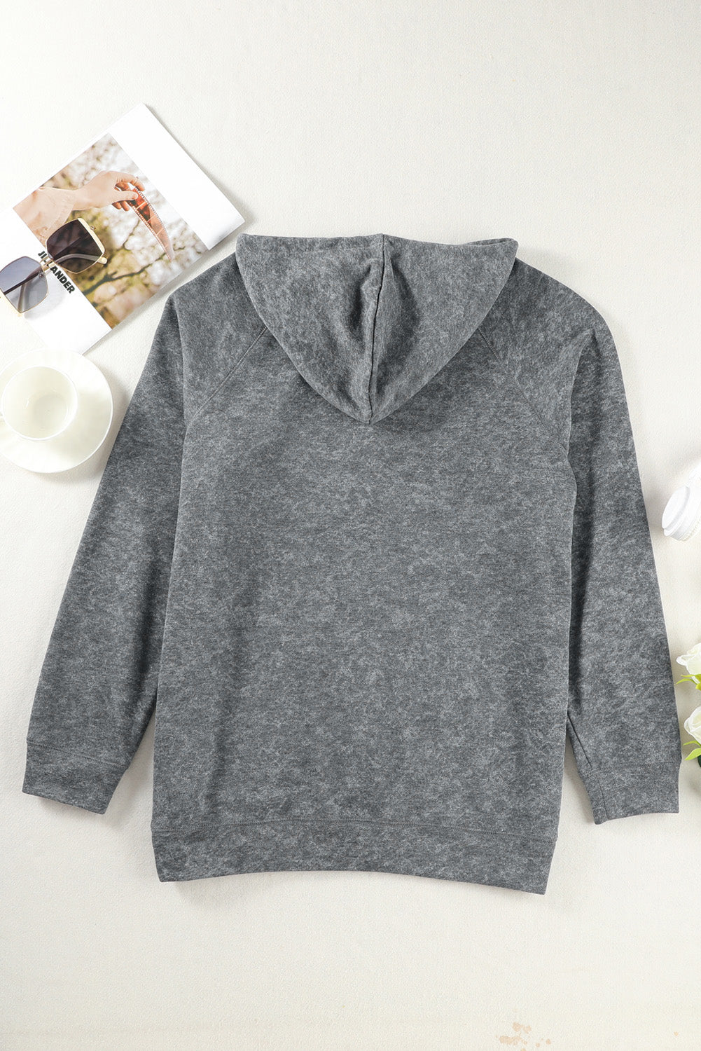 A person with blonde hair is standing with their back to the camera, wearing a Gray Mineral Wash Kangaroo Pocket Drawstring Pullover Hoodie.