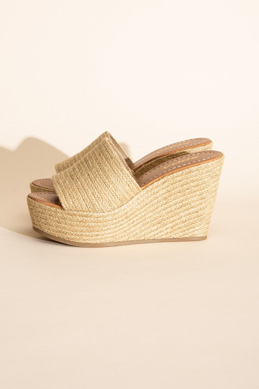 A pair of Bounty-S Wedge Platform Heels featuring a beige woven straw-like texture, open toe straps, and brown insoles.