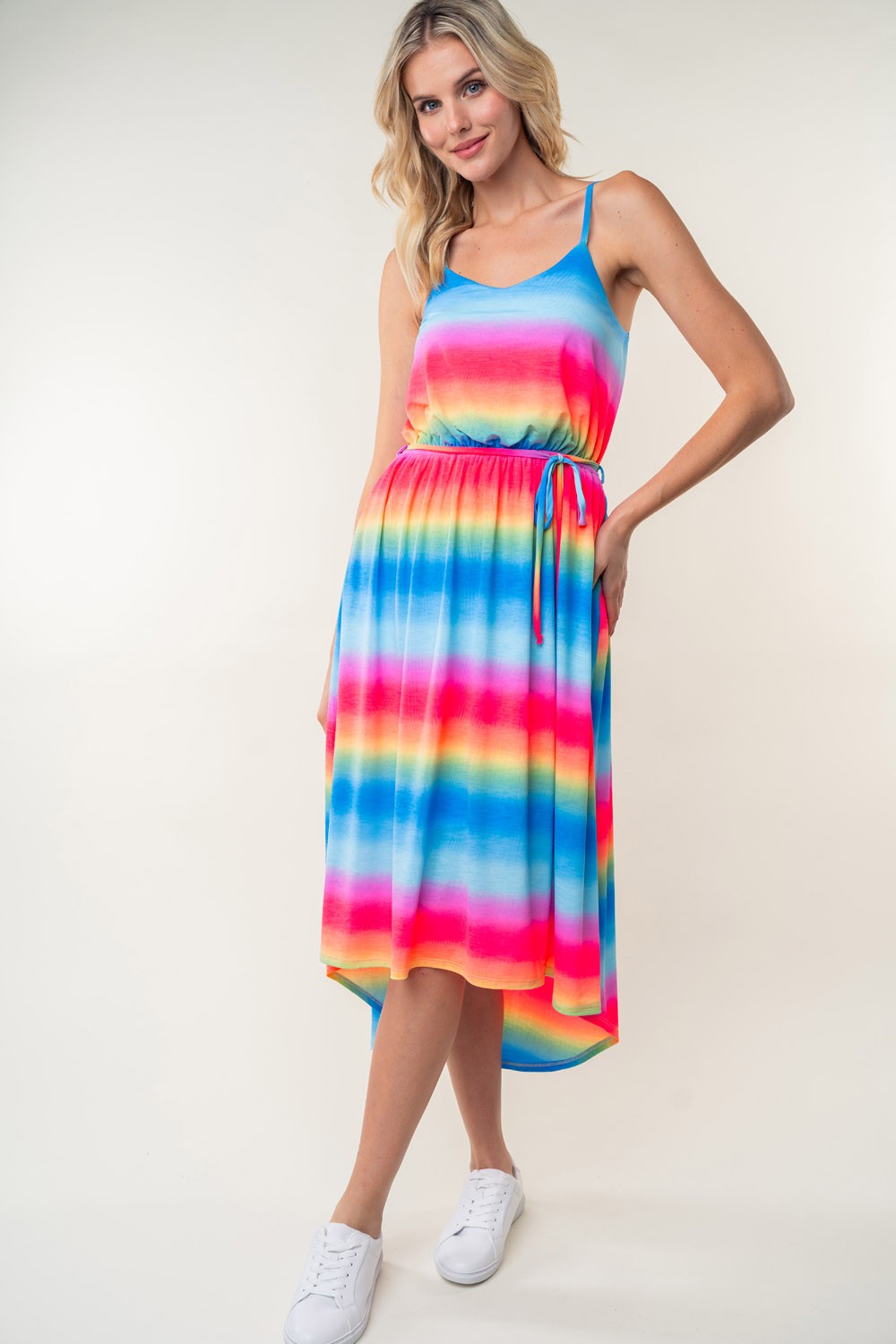 A person in a White Birch Full Size Ombre Striped Midi Cami Dress paired with white sneakers stands against a plain background.