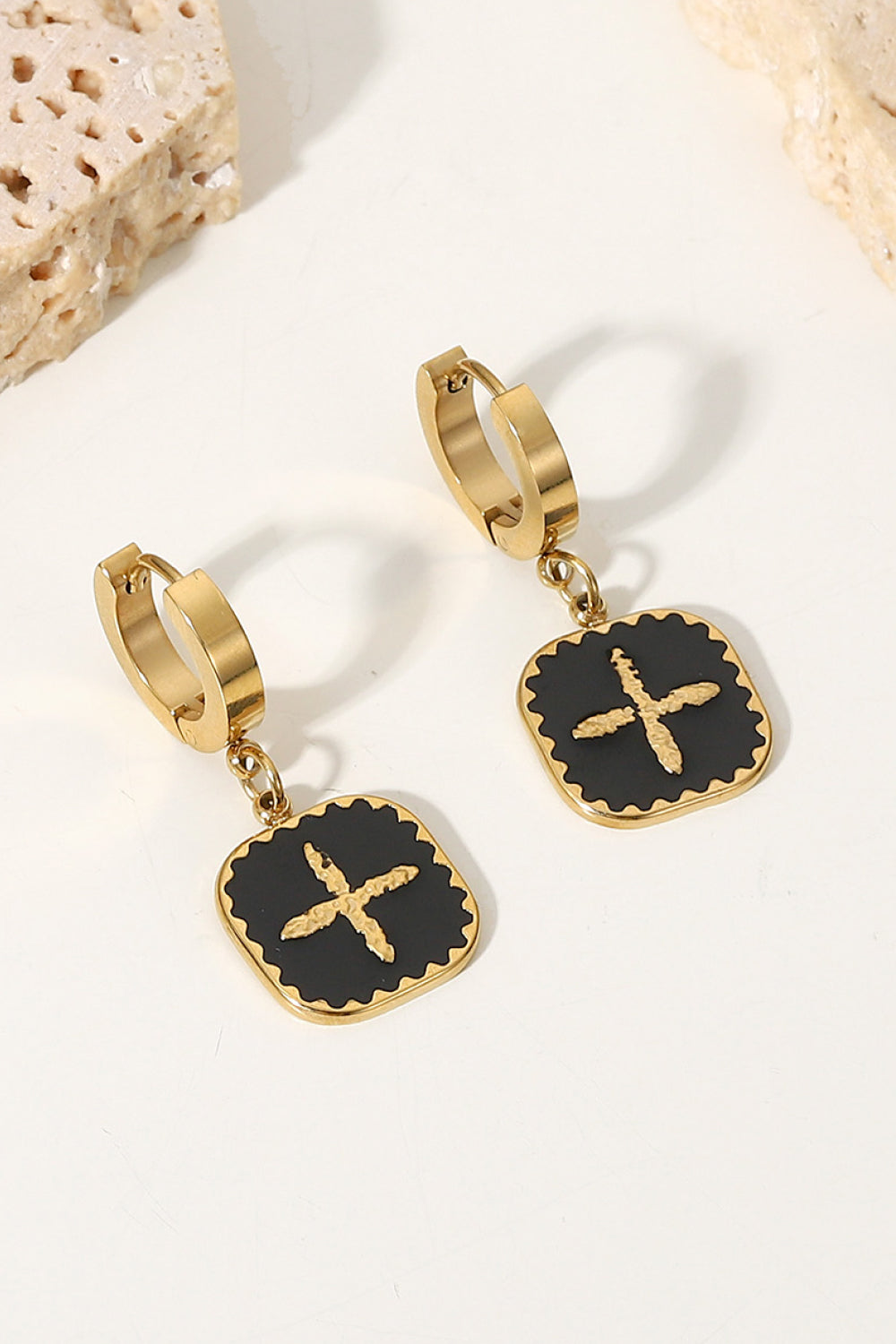 The Plus Sign Square Shape Drop Earrings are a pair of gold hoop earrings featuring square black pendants with a stylish gold plus sign design in the center, crafted from durable stainless steel jewelry.