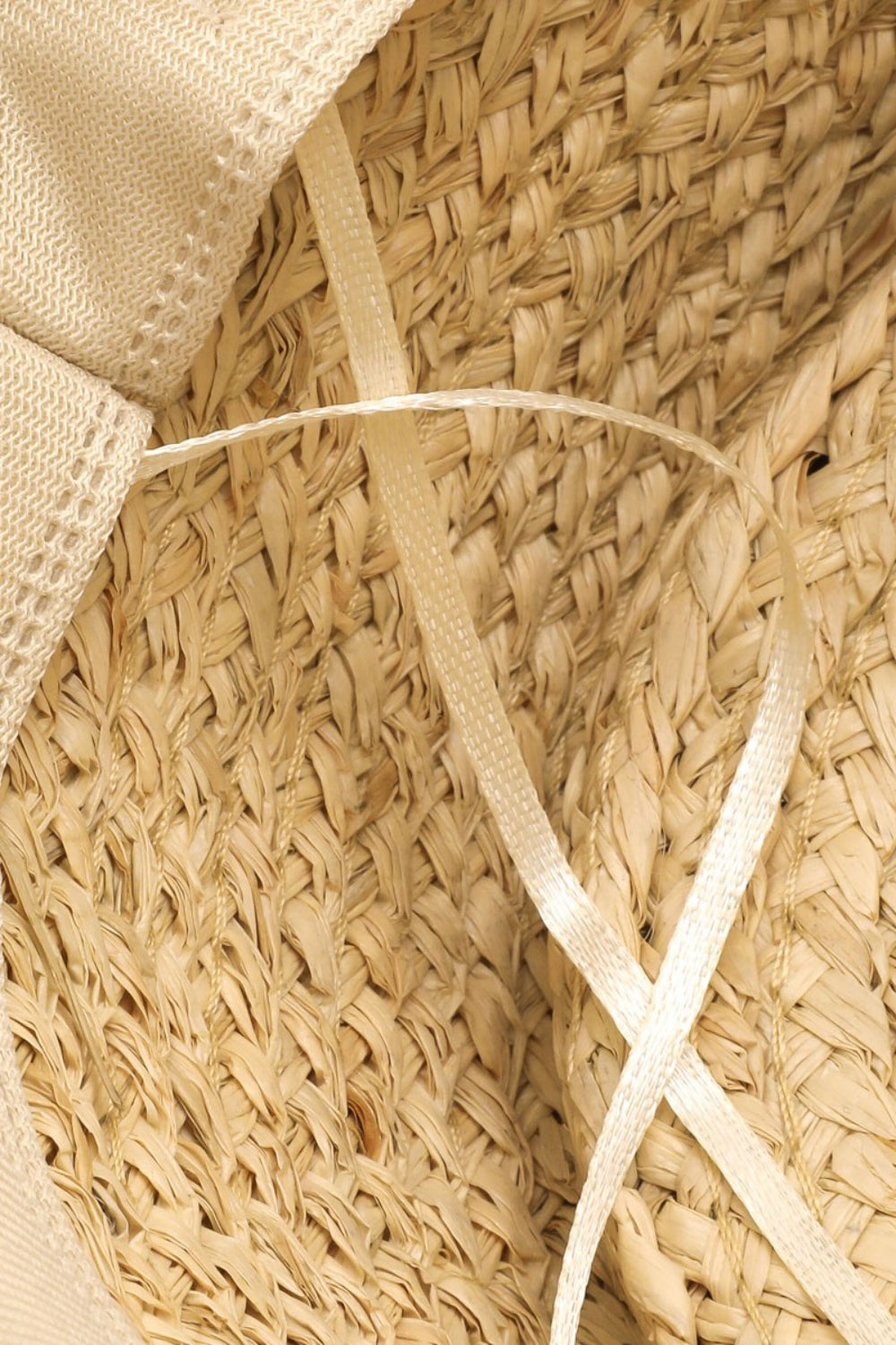 A person smiling in a Fame Wide Brim Straw Weave Hat and a white tank top epitomizes the ideal summer wardrobe against a light background.