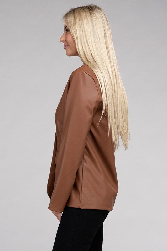 A person with long blonde hair wears the Sleek Pu Leather Blazer with Front Closure over a black top, standing against a plain background.