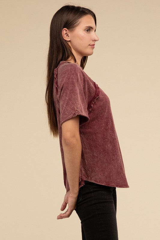 A person with long brown hair wearing a Back Patch Crinkle Washed Raglan Sleeve T-Shirt stands against a plain beige background.