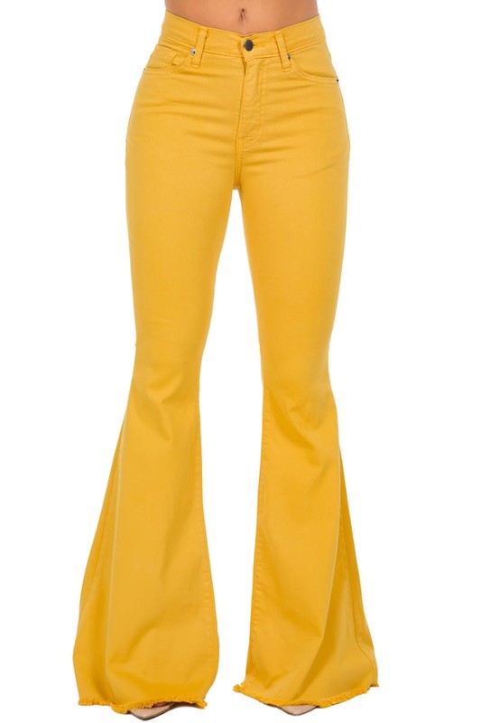 Person wearing the Bell Bottom Jean in Mustard with a 30-inch inseam, featuring a high-waisted fit and frayed hem.