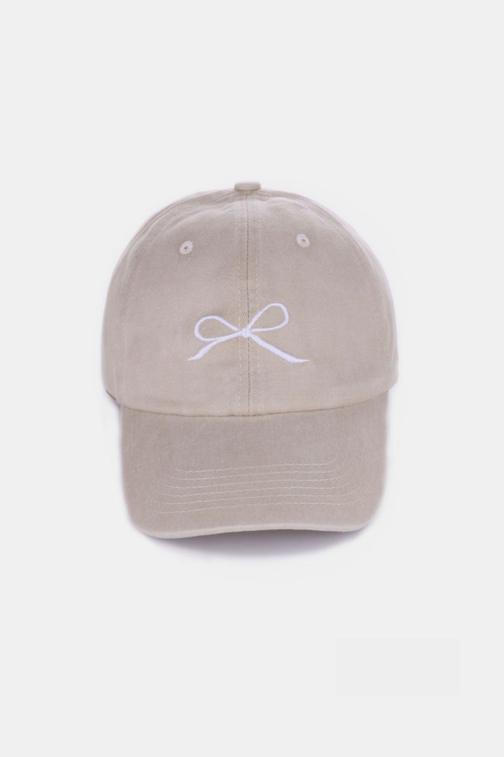 The Zenana Bow Embroidered Washed Cotton Cap features a pink design with a stylish white bow on the front, set against a plain, light background. This chic accessory seamlessly combines elegance and sportiness.