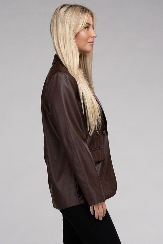 A person with long blonde hair wears the Sleek Pu Leather Blazer with Front Closure over a black top, standing against a plain background.