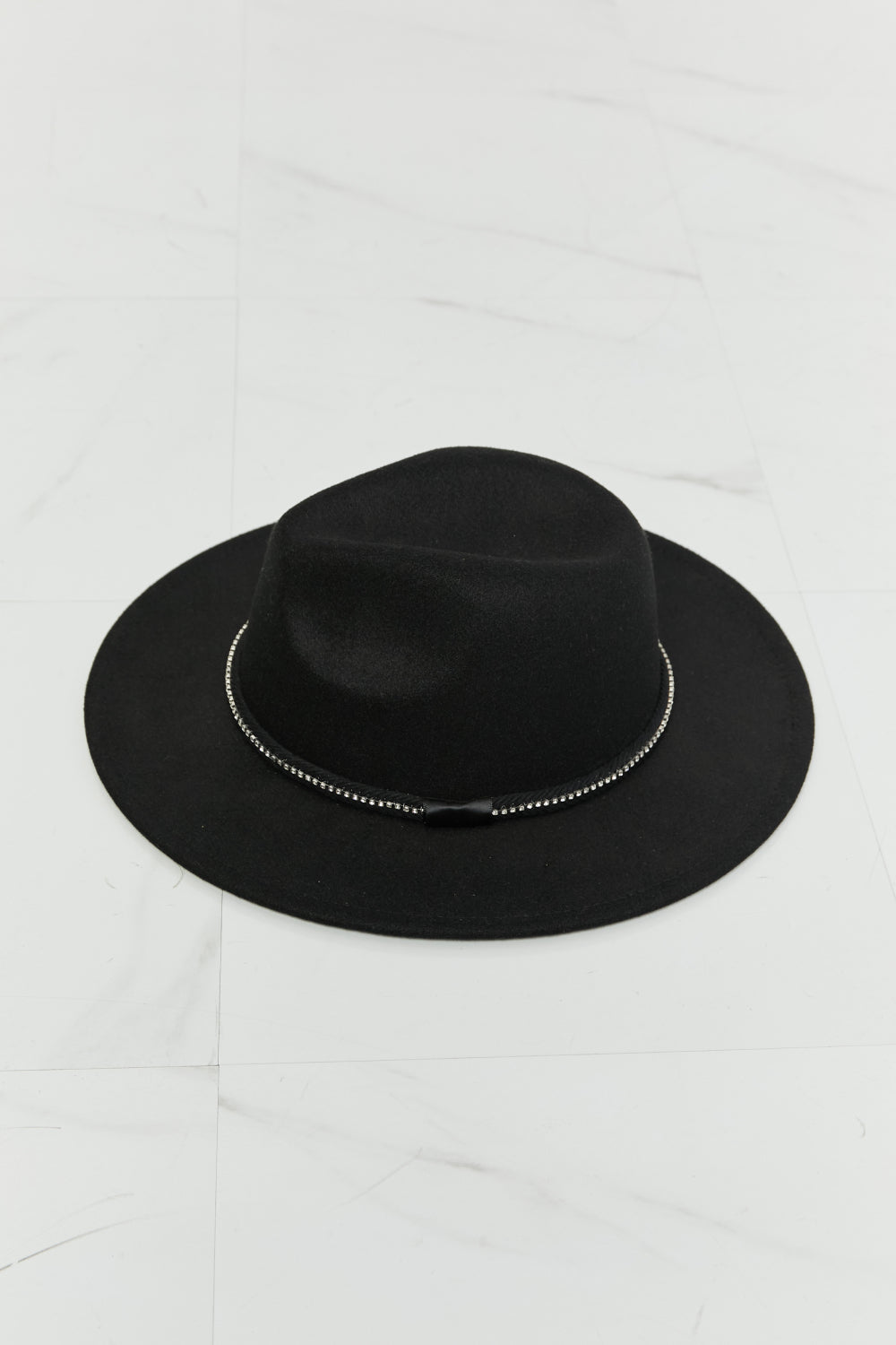 Person with long wavy hair wearing the Fame Bring It Back Fedora Hat, which features a black wide brim and rhinestone detailing, paired with a white tank top, viewed from the back.