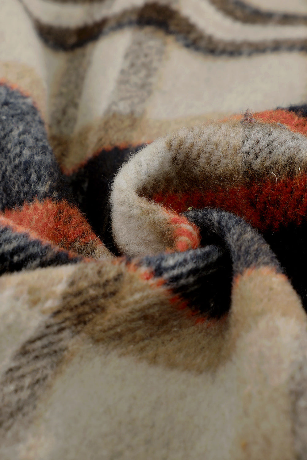 A person wearing a Brown Plaid Button Up Long Sleeve Flannel Shacket layered over a white top with ripped jeans and holding a brown handbag stands against a textured gray wall.