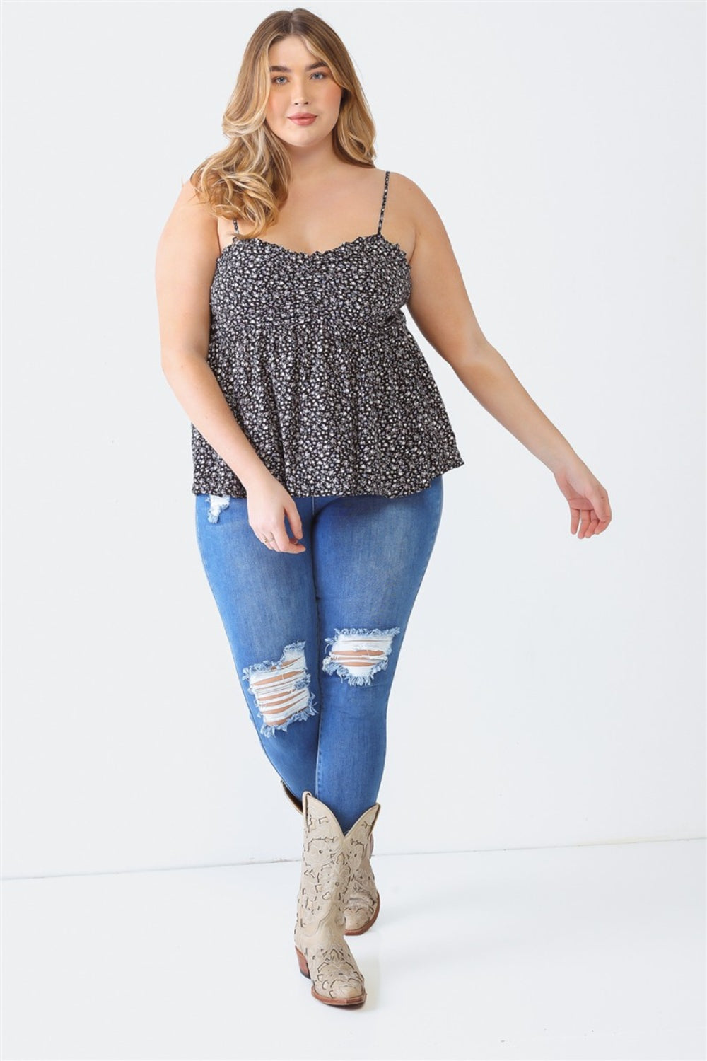 A woman stands facing the camera wearing a Zenobia Plus Size Frill Smocked Floral Sweetheart Neck Cami with dark jeans, against a plain background.