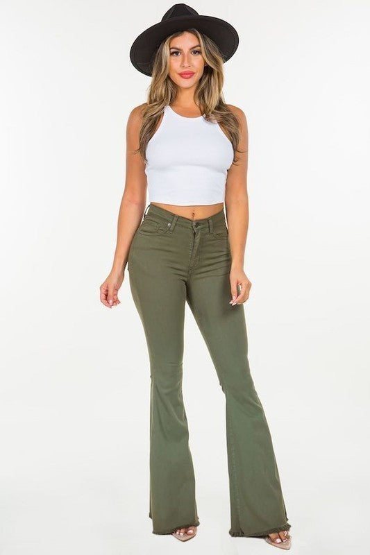 A person wearing the Bell Bottom Jean in Olive, high-rise pants with a 30" inseam, made in the USA, with their torso and feet partially visible against a plain background.